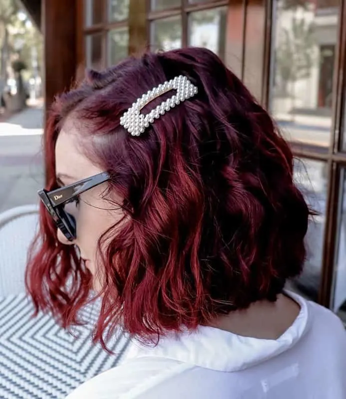 tousled long bob of red brown curly hair